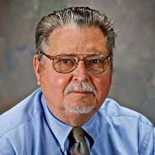 Obituary: TOM STRICKLAND