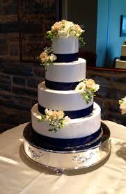 Simple 4 Tier Buttercream Wedding Cake With Navy Blue Ribbon And Fresh Flowers Thebakersbox Wedding Cakes Simple Blue Simple Wedding Cake Wedding Shower Cakes