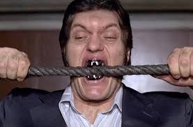 Andre the Giant biting a cable.
