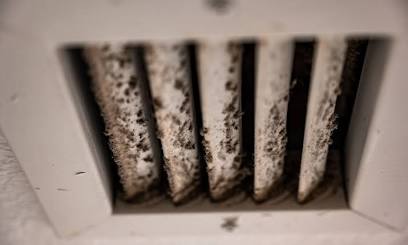 Uncleaned AC vents circulate dust mites and mold spores into living spaces., AI generated