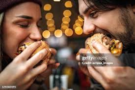 1.405 Burger Couple Indoor Stock Photos, High-Res Pictures, and Images