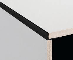 It has three small metal tabs around the edge which you fold over to secure it in place. Dta Tile Trim Aluminium Angle 20mm Brush Black 3 Metre