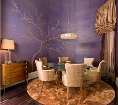 A stylish dining room with bare walls, hardwood floor, a long glass table, statement purple chairs, and simple rustic accents. 15 Purple Dining Room Ideas Home Design Lover