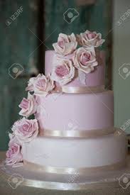 This video tutorial will show you how to make sugar flowers to decorate you own wedding cake. Pastel Pink Wedding Cake With Sugar Paste Roses Behind The Cake There Is A Green Wooden Door Stock Photo Picture And Royalty Free Image Image 98408067