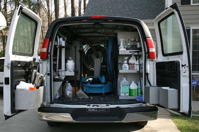 Truck-mounted hot water extraction wand cleaning a carpet in a Commerce City home