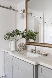 A Gold Leaf Beveled Vanity Mirror Hangs Above A Gray Extra Wide Single Bath Vanity Fit Vintage Bathroom Vanities White Quartz Countertop Master Bathroom Design