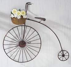Inspired by vintage transportation and the bicycles of yesteryear, this large and rustic metal bike features an exaggerated back wheel. Primitive Country Bicycle Metal Wall Art Metal Tree Wall Art Primitive Decorating Country Bicycle Wall Art