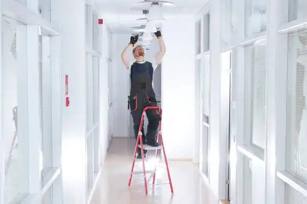 Certified fitter installing a pendant light in SE18