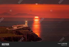 If you like to be higher up, then watching the sunset from the highest point in this photograph is highly recommended, offering great sunset views. Neist Point Lighthouse Image Photo Free Trial Bigstock