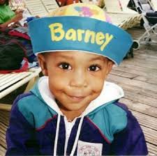 An old photo of me as a little boy with a Barney doll. The t-shirt I'm  wearing has Barney