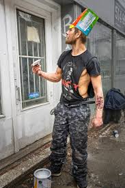 Jean-Philippe, homeless, stands at the corner of Saint-Laurent and  Sainte-Catherine under the melting snow