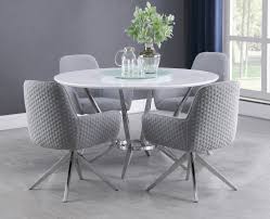 Stunning monochromatic dining room boasts exposed brick walls painted white lined with an l shaped light gray upholstered dining banquette facing a round marble top dining table and light grey french x back chairs illuminated by a brass and glass lantern. Abby 5 Pc White Light Grey Chrome Dining Table Set By Coaster