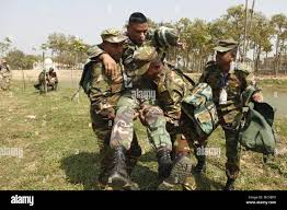 Bangladesh Army soldiers practice giving medical aid to role-players during  a simulated mass casualty training event as part of Exercise Shanti Doot 4  in Bangladesh. Shanti Doot 4 is a multinational United