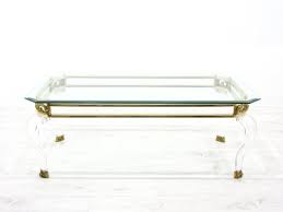 This hollywood regency coffee table is a mix of molded and painted resin, gilt metal (legs), composite material (base platter), and capiz shells under clear resin. Hollywood Regency Coffee Table 1980s For Sale At Pamono