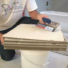This refers to evenly spreading adhesive on the back of tile with a trowel before setting. Back Butter Buddy Contractors Direct