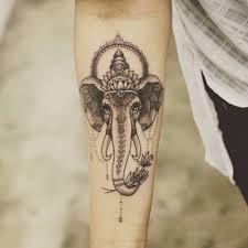 You could get the face of buddha in the background of the tattoo, along with the outline of the om symbol. 18 Totally Zen Yoga Tattoos To Keep You Centered Brit Co