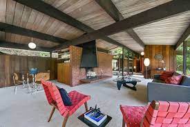 The gas fireplace is offset and because of that has never looked right to me. Mid Century Modern Home Clad With Wood Of Various Shades Digsdigs