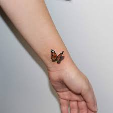 Four gaudy butterflies on forearm. Small Wrist Small Butterfly Tattoo Ideas Tattoo Design
