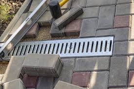 Shows an underground downspout drainage system to remove roof rain water away from the building foundation into ground through a french drain with a lawn po. Exterior French Drain Downspout Drain Morgantown Wv