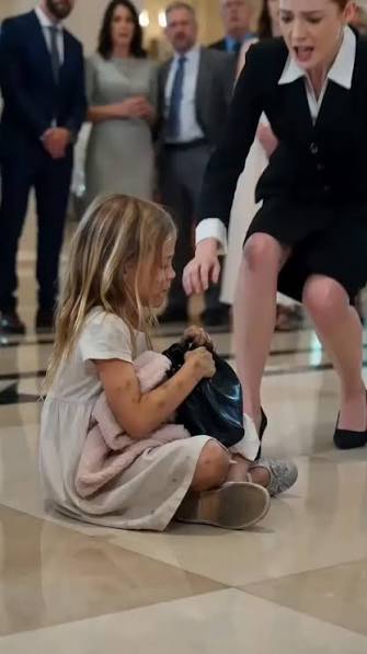 The little girl slammed against the marble floor so hard that the sound echoed across the entire hotel lobby....., But even then…, she refused to let go of the designer handbag., Her tiny fingers ...