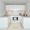 The white bottom cabinets feature faux raised legs, and instead of closed shelving, they opted for airy, welcoming open shelving—all the better for displaying china. 1