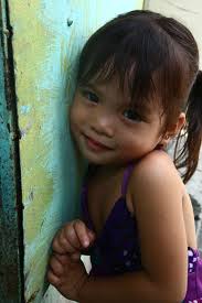 A little girl poses for a photograph during a medical