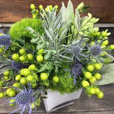White blossoms emerging from dark leaves set in a natural wicker basket convey lasting peace and. A New Leaf