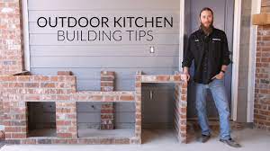 In this space, wood and simple brick complement the small space, providing prep areas and a base for the grill. Outdoor Kitchen Planning Building Process The Watson Family S Kitchen Build Bbqguys Com Youtube