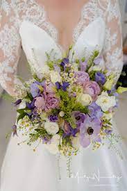 Purple bridal bouquets & bridesmaid bouquets + wedding decorations. Rich Textured Bridal Bouquet Of Mixed Tonal Ivory Lilac And Purple Flowers With Contrasting Wedding Flower Arrangements Wedding Bridal Bouquets Bridal Bouquet