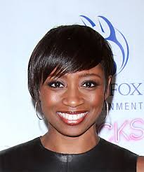 Cutting with elevation removes bulk, which allows this longer fringe to flow up and back instead of hanging low and flat. Montego Glover Black Pixie Cut With Side Swept Bangs