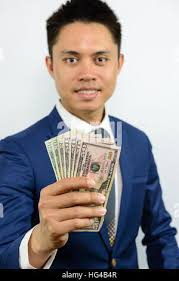 Man hand reaching out dollar bill. Hand holding dollar bill, US $100  banknote Stock Photo