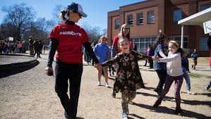 Students, parents, teachers join to "Hug Our School" at Stone Academy