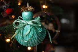 Just dip pinecones in white paint and dust them in a little gold for total glam vibes. Seashell Angel Ornament For Kids To Make Happy Hooligans