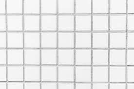 Two minimalist glass pendant lights are hung above a kitchen island. Free Photo White Tiles Textures