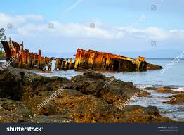 rusty junk boat sinked water on stock