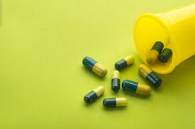 Premium stock photo of green and yellow capsule in transparent blister pack. Some Capsules Greens Isolated On A Yellow Background Conceptual Image Pain Addiction Stock Photo 222317606