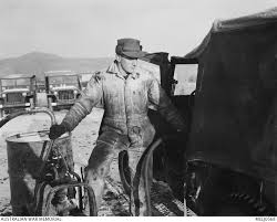 Filling his jeep tank from a snow covered drum is 26217 Private (Pte) Dick  Sterling Hammond of ...