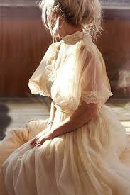 Unique Wedding Dresses Blonde Woman Sitting Down With Hands In Lap In A Victorian Cream Wedding Dress Wit 1970s Wedding Dress Vintage Dresses Wedding Dresses