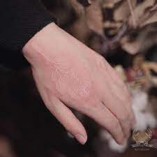 As for others, it's almost invisible unless they walk close to you. White Ink Rose Tattoo On The Left Hand