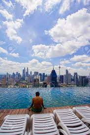 Spending quality time with your loved one is crucial. A Traveller Sitting On Rooftop Swimming Pool Watching Kuala Lumpur Stock Photo Picture And Royalty Free Image Image 89177655