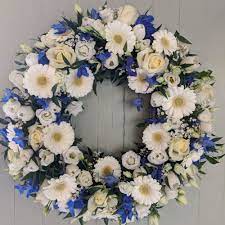 Pairing blue and white funeral flowers for a funeral arrangement or as a way to show sympathy to those who have lost a loved one is the perfect way to express your feelings of there's no going wrong with this quintessential funerary bloom to express the love you still feel for those who have departed. Send A Royal Blue And White Wreath Funeral Flower Tribute To Sussex