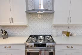 White Shaker Kitchen Cabinet With Arabesque Gloss Tile Backsplash White Shaker Kitchen Cabinets White Kitchen Rustic White Shaker Kitchen