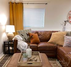 Every time i get ready to share a finished space, i'm truly amazed at how far the space has come. A Cozy Basement Family Room With Rust And Yellow Jennifer Rizzo