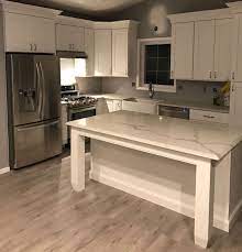 That way the flooring can be changed down the road without trying to get it out from under the cabinets. Coretec Vinyl Plank Flooring In A Light Gray Color Coretec Vinyl Plank Flooring House Flooring Light Gray Vinyl Plank Flooring