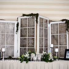 reused windows to display seating arrangements at wedding