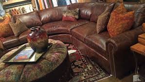 Brown Distressed Leather Sectional Sofa And Round Tufted Ottoman With Leather Fringe Distressed Leather Sofa Leather Sectional Round Tufted Ottoman