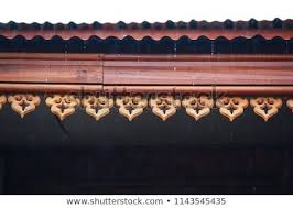 detail of wood carvings on awning of thai house in thailand wood house in rainy day maison thai maison bois