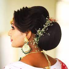 What A Beautiful Large Low Bun With Real Flower Gajra Care However Should Be Taken Before Adopting Such Hairstyles As Big Bun Hair Hair Styles Bun Hairstyles
