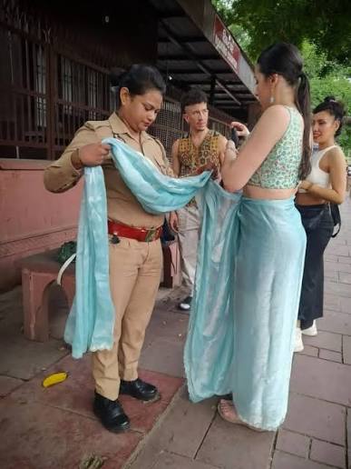 A video showing a UP Police constable helping a foreign guest drape a traditional Indian saree has gained attention on social media. Many viewers appreciated the gesture as an example of kindness,