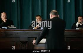 State Appellate Judge Rick Elmore, left, and Judge Eric L. Levinson, right,  listen as Judge James A.Wynn Jr., center, engages state attorney William  Crumpler (center back) during the murder appeal of Michael